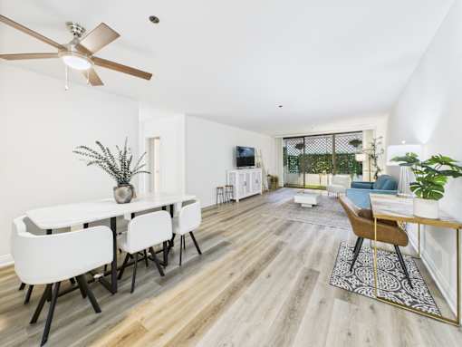 A dining room with a white table and chairs.
