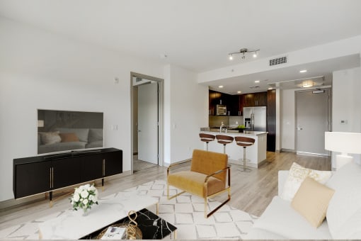 a living room with a couch and a kitchen in the background