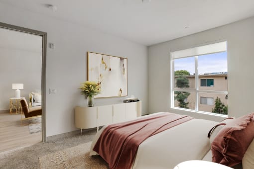 a bedroom with a bed and a large window