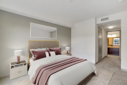 a bedroom with a bed and a door to a bathroom