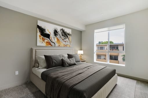 a bedroom with a bed and a large window