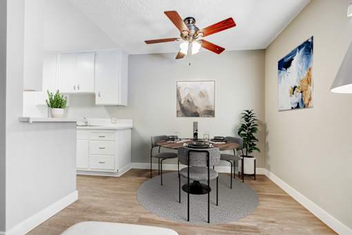 A dining room with a table set for four.