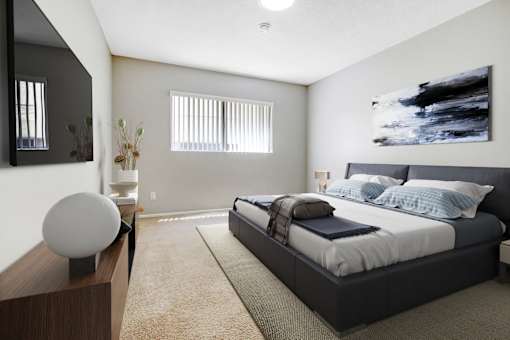 A modern bedroom with a large bed and a large painting on the wall.