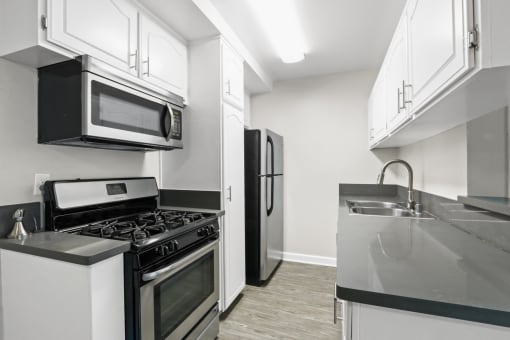 a kitchen with stainless steel appliances and white cabinets