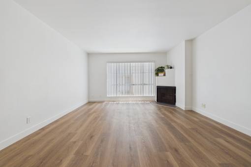 A room with wooden floors and white walls.