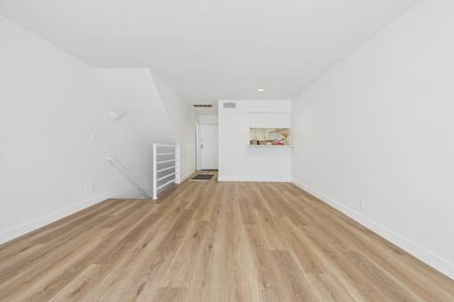 A room with wooden floors and white walls.
