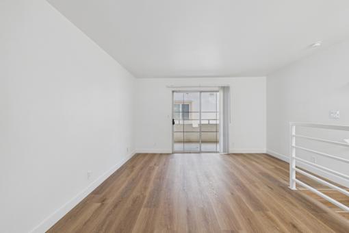 A room with wooden floors and white walls.