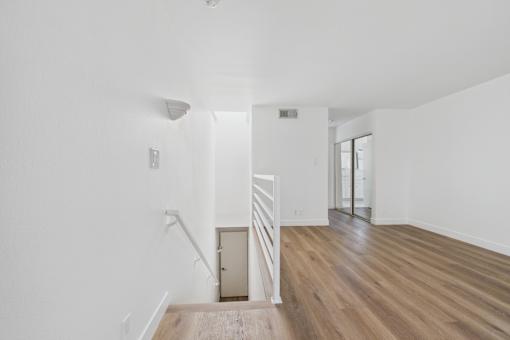 A room with wooden floors and white walls.