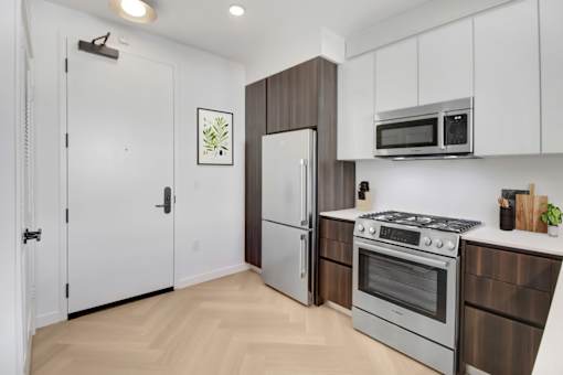 A kitchen with a stove, oven, and refrigerator.