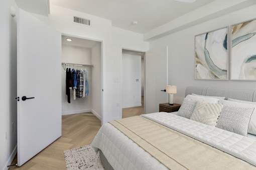 A bedroom with a large bed and a wardrobe.