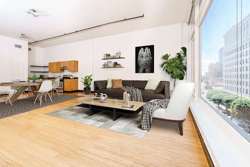 a living room with a couch and a table and a large window