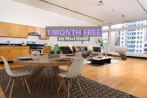 A modern living room with a dining table and chairs is on sale for 1 month free on most units.
