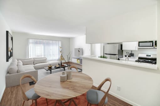 a living room with a table and a couch and a kitchen