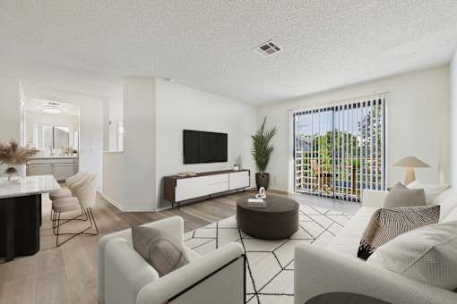 A living room with a white couch and a television.