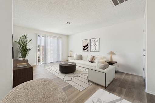 A living room with a white couch and a coffee table.