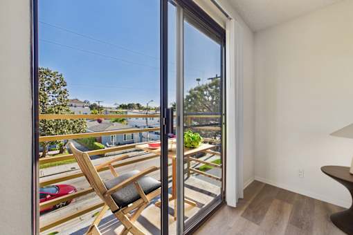 A chair is placed in front of a sliding glass door.