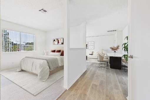 A bedroom with a bed and a chair in it.