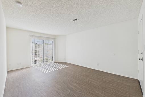 A room with a sliding door and a window.