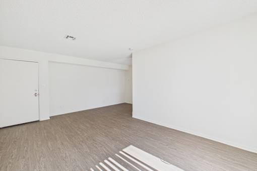 A room with a white door and a white wall.
