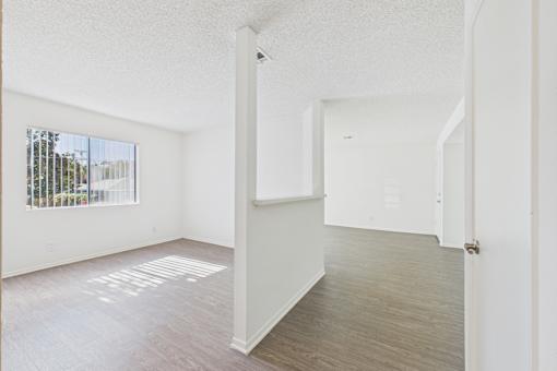 A white room with a door and a window.