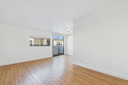 A room with wooden floors and white walls.