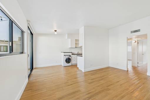 A room with a washer and dryer stacked on top of each other.
