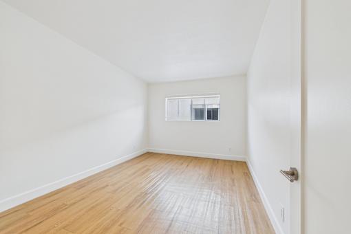 A room with wooden floors and white walls.