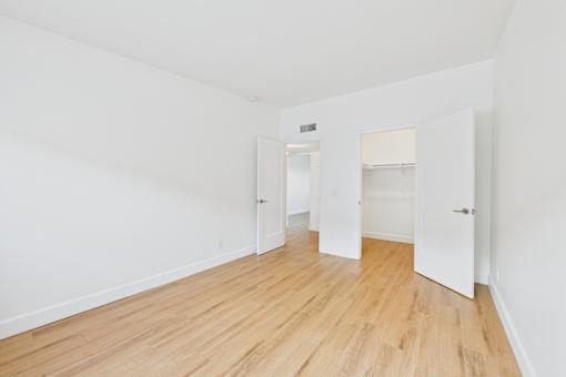 A room with wooden floors and white walls.