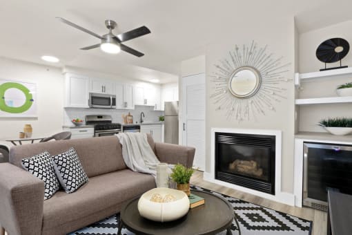 a living room with a couch and a coffee table in front of a fireplace