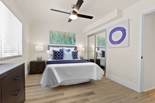 a bedroom with a bed and a ceiling fan