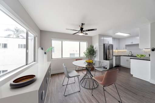 A modern kitchen with a dining table and chairs.