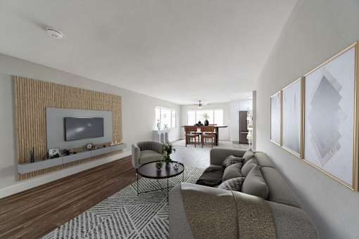 A living room with a grey sofa and a television.