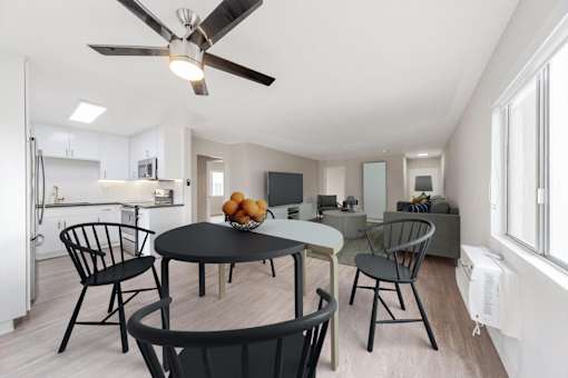 A modern kitchen with a dining table and chairs.