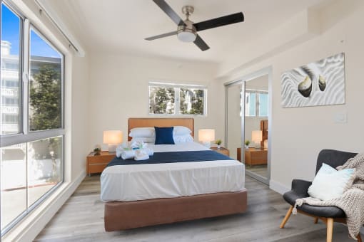 a bedroom with a bed and a ceiling fan