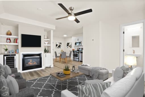 a living room with white walls and a fireplace with a flat screen tv above it