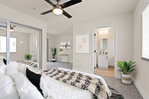 a bedroom with a large bed and a ceiling fan