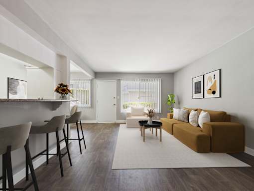 A living room with a brown couch and a white chair.