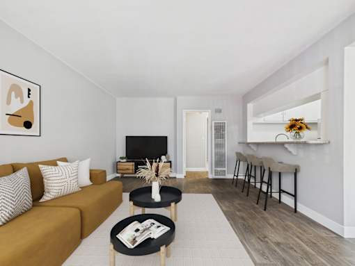 A living room with a brown sofa and a coffee table.