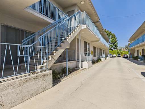 A blue staircase leads to a building entrance.