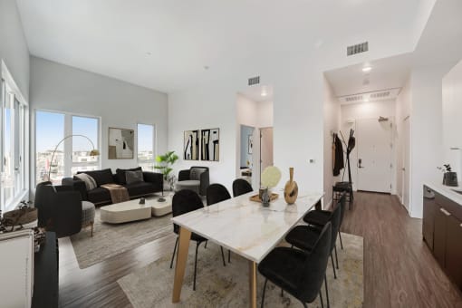 a dining room with a table and chairs and a living room with couches