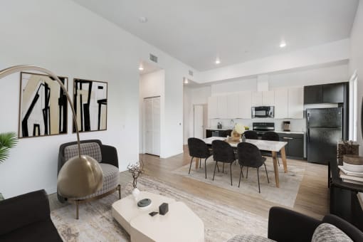 a living room and dining room with a table and chairs