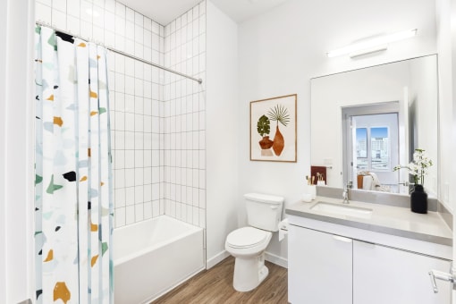 a bathroom with a shower and a toilet and a sink