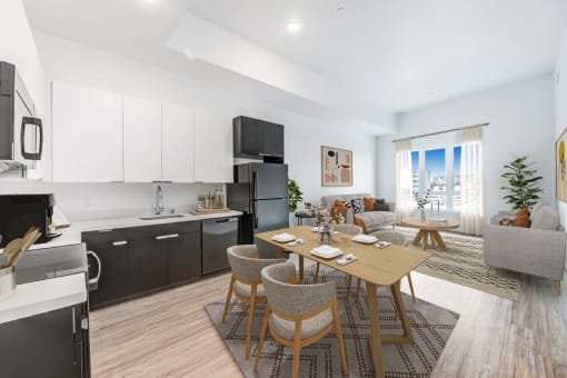 a living area with a dining table and a kitchen