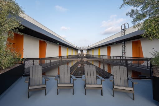 a patio with rocking chairs on a balcony