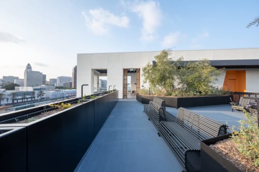 a long terrace with benches and a view of the city