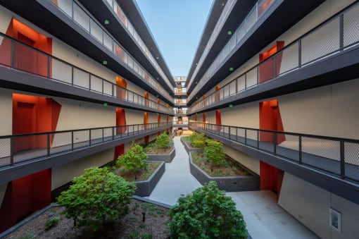 an inner courtyard of an apartment building with trees and plants