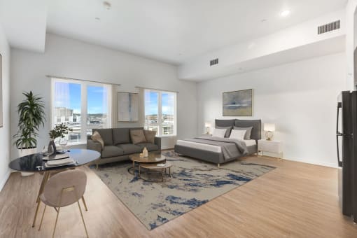 an open living room with a bed and a couch