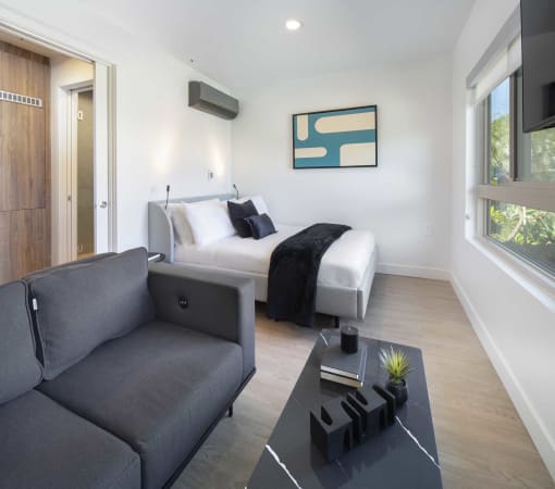 a rendering of a hotel room with a bed and a couch