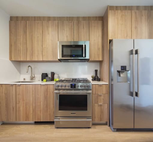 a kitchen with stainless steel appliances and wooden cabinets