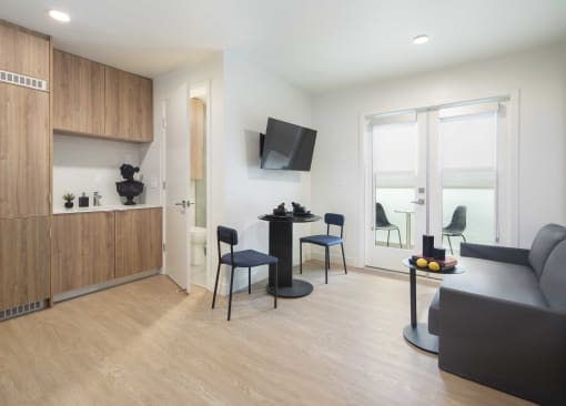 a living room with chairs and a table